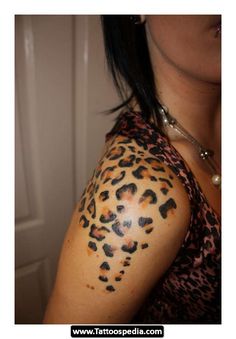 a woman with a leopard print tattoo on her arm