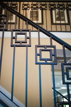 an iron stair railing with square designs on it