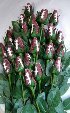 a bunch of flowers that have been decorated with white and red footballs on them