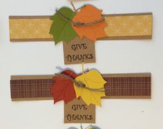 a cross made out of autumn leaves with the words give thanks written on each one