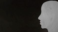 the silhouette of a man's head is shown against a black background with white paint