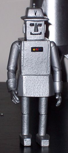 a silver robot is standing on a table