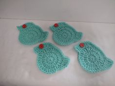 three crocheted birds sitting on top of a bed