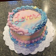 there is a cake that has the word love written in frosting on top of it