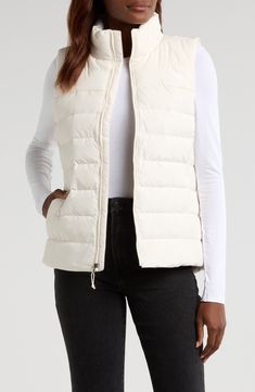 Experience the core warmth you need without restricting mobility in a lightweight puffer vest insulated with a blend of down and recycled polyester. 25 1/2" length (size Medium)   50-denier, 73 g/m² recycled polyester   Durable water-repellent (DWR) finish   Lined, with 50% 600-fill-power down, 50% recycled-polyester fill   100% recycled polyester   Machine wash, line dry   Imported   PFC-free, durable water-repellent coating is free of per- and poly-fluorinated chemicals, some of which can be h Casual The North Face Nylon Puffer Jacket, Casual Nylon Puffer Jacket By The North Face, White Puffer Vest, White Puffer, Outerwear Vest, Puffer Vest, Outerwear Women, Repellent, Water Repellent