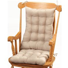 a wooden rocking chair with a cushion on it's back and seat padding