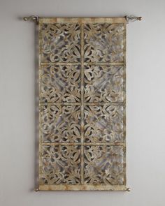 a wall hanging on the side of a white wall