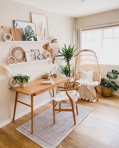 a wooden table sitting in the middle of a living room next to a chair and potted plant