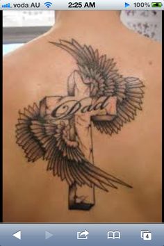 the back of a woman's shoulder with a cross and an eagle on it