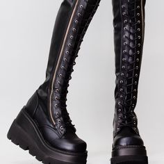 These Bada$$ Festival Boots Feature A Black Vegan Leather Outer, And Lace Up Front With Exterior Side Zipper. 4 1/2" Wedge Platform Vegan Leather Lace-Up Front Thigh-High Rise Full Length Exterior Metal Zipper Black Laces Black Fall Concert Knee-high Platform Boots, Knee-high Platform Boots For Fall Concerts, Fall Knee-high Platform Boots For Concerts, Fitted Platform Boots For Alternative Fashion, Punk Knee-high Platform Boots For Party, Black Round Toe Knee-high Boots For Club, Punk High-top Fitted Platform Boots, Fitted High-top Punk Platform Boots, Punk Style Fitted High-top Platform Boots