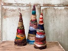 three small colorful cones sitting on top of a wooden table