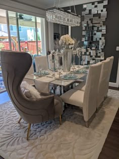 a dining room table with chairs and a chandelier