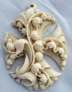 an intricately carved piece of wood on a white surface