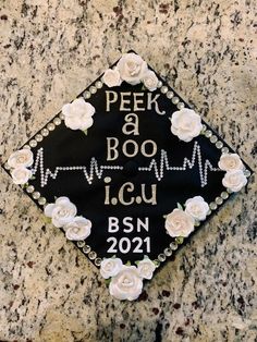 a decorated graduation cap with flowers on it