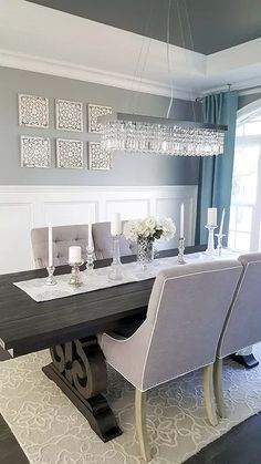 the dining room table is set with white chairs