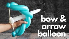 a hand holding an inflatable balloon with the words bow & arrow balloon on it