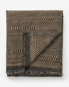 a black and brown blanket with fringes on it