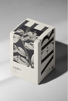 an open box with black and white designs on the front, sitting on a gray surface