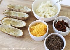 the ingredients for baked potato casserole are arranged in small bowls on a cutting board