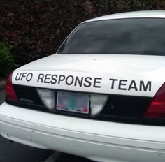 a white police car parked in a parking lot with the words ufo response team on it