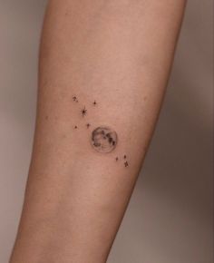 a woman's arm with stars and the moon on it