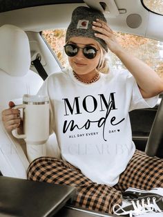 Introducing the perfect gift for moms - our "Mom Mode" t-shirt! Designed for all-day wear, this shirt will remind you of your superpowers while looking stylish. Comfortable and practical, it's the perfect addition to any mom's wardrobe. Get one for yourself or the amazing moms in your life! PREORDER REMINDER: PLEASE order ahead of time so that we have enough time to process/pack & ship your order. Thanks! 😊 ORDER INCLUDES: - Your Choice of T-shirt - Care Card - FREE gift  SIDE NOTE: Actual prod Mom Wardrobe, Trendy Mom, Perfect Gift For Mom, Trendy Tshirts, Super Powers, Snug Fit, Are You The One, Gifts For Mom, Adult Outfits