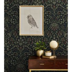 an ornate wallpapered room with a bird on the wall and two vases next to it