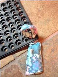 an object is laying on the ground next to a grate