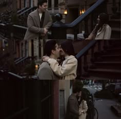 two people standing next to each other in front of a building and one person kissing the other