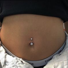 a woman's stomach with a small diamond on the side, in front of her belly