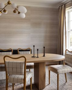 a dining room table with four chairs around it