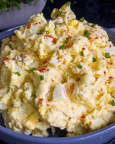 a blue bowl filled with mashed potatoes on top of a table