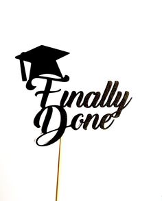 a cake topper that says finally done with a graduation cap on it and the words'finally done'in cursive writing