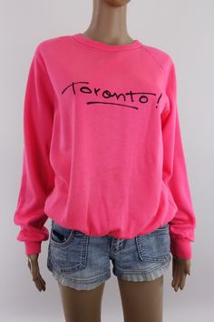 Rare vintage 80s sweatshirt in neon pink with 'Toronto!' in black on the front.  I believe these were sold at the City store on Queen Street West. Label was snipped out but material feels like a cotton polyester blend.  The neon is a bit deeper and more vibrant than my camera could capture.  Condition notes: some fabric thinning consistent with age and use, some faint blotchy discoloration on the front, some black specks here and there (front, one sleeve and cuff), tiny hole back of neck, some d Vintage Toronto, 80s Sweatshirt, 80s Neon, Womens Sweatshirts, Sweatshirt Crewneck, Pink Sweatshirt, Vintage Sweatshirt, Neon Pink, Size Tag