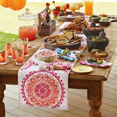 a wooden table topped with lots of food