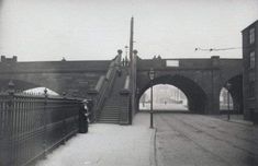 an old black and white photo of a bridge