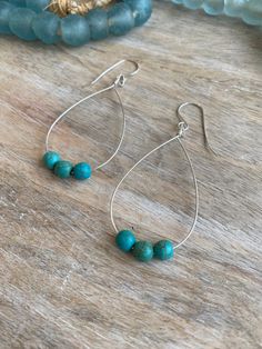 A beautiful, dainty, minimalistic pair of lightweight sterling silver teardrop hoop earrings with a smooth finish. Made with round turquoise beads.  Handmade in Santa Cruz and South Lake Tahoe, California DETAILS  - Hoops and ear wires are sterling silver and great for sensitive ears - Turquoise beads - Each piece is handmade - please allow for slight variation - Approximately 1 inches wide and 2-2.5 inches long (not including ear wire) INCLUDED - Earrings are carefully packaged in a gift box - We ship in a bubble mailer to ensure maximum protection. CUSTOM ORDERS & GIFTS - Looking for something different or wanting a custom piece? Please contact me directly! RETURNS & EXCHANGES - Returns and exchanges are not available. However, if there is an issue with your order upon receiving your pac Teardrop Hoop Earrings, Tahoe California, Lake Tahoe California, South Lake Tahoe, Beads Handmade, Jewelry Earrings Hoops, Lake Tahoe, Turquoise Beads, Ear Wire