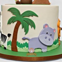 there is a cake decorated with animals and trees