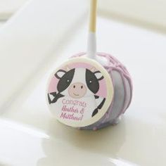 a pink and white cake pops with a cow on it