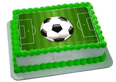 a soccer field cake with a soccer ball on it