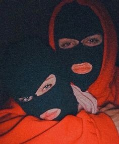 a person wearing a black mask and orange hood on top of their head in bed