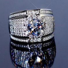 a diamond ring sitting on top of a reflective surface