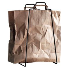 a brown paper bag sitting on top of a metal stand with two handles and one handle