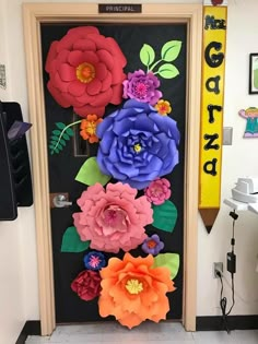 a door decorated with paper flowers and leaves