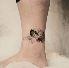 a woman's foot with a black and white tattoo on the side of her leg