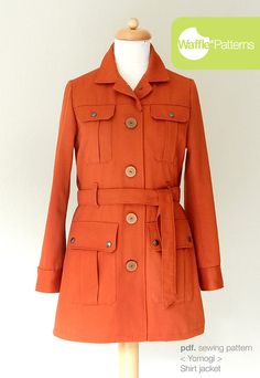 an orange trench coat on a mannequin stand with the words wait patterns below it