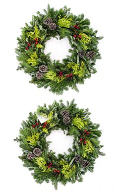 two christmas wreaths with pine cones and berries