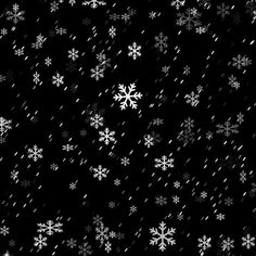 snow flakes falling down on a black background