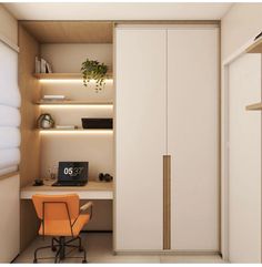 an office with a desk and chair next to a closet door that has a clock on it