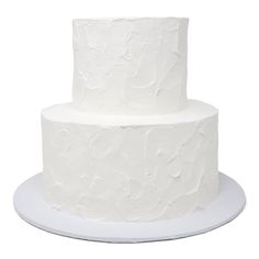 a three tiered white cake with icing on a plate, isolated against a white background